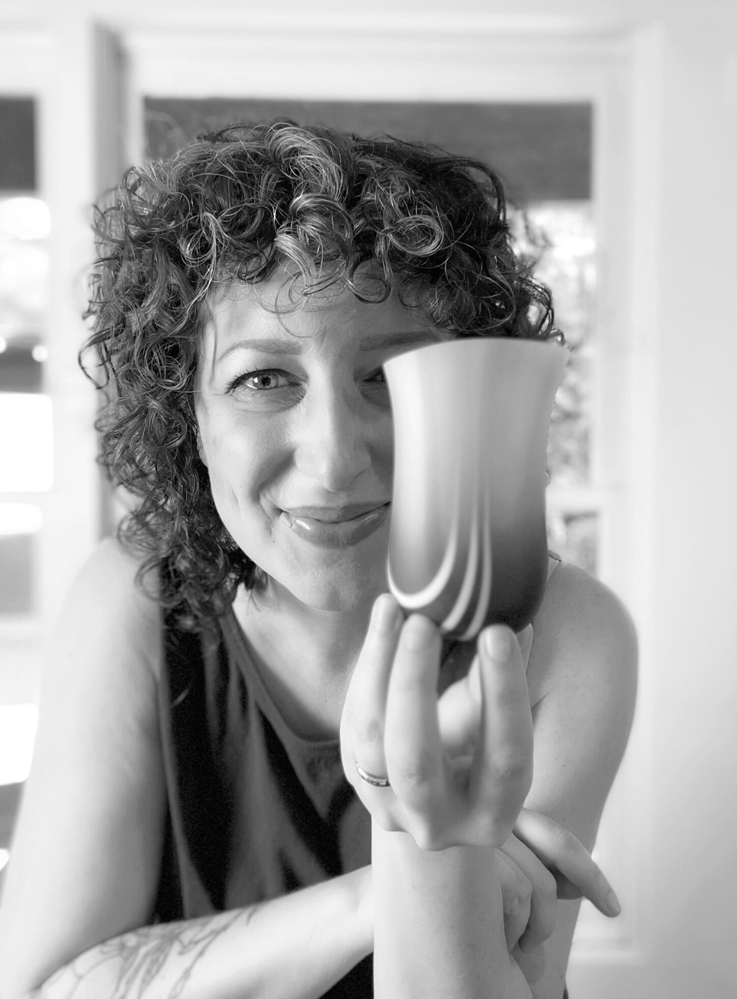 Sarah Noble, Atlanta Glass Artist Atlanta kiln-formed glass artist Sarah Noble holds a handmade art glass vase